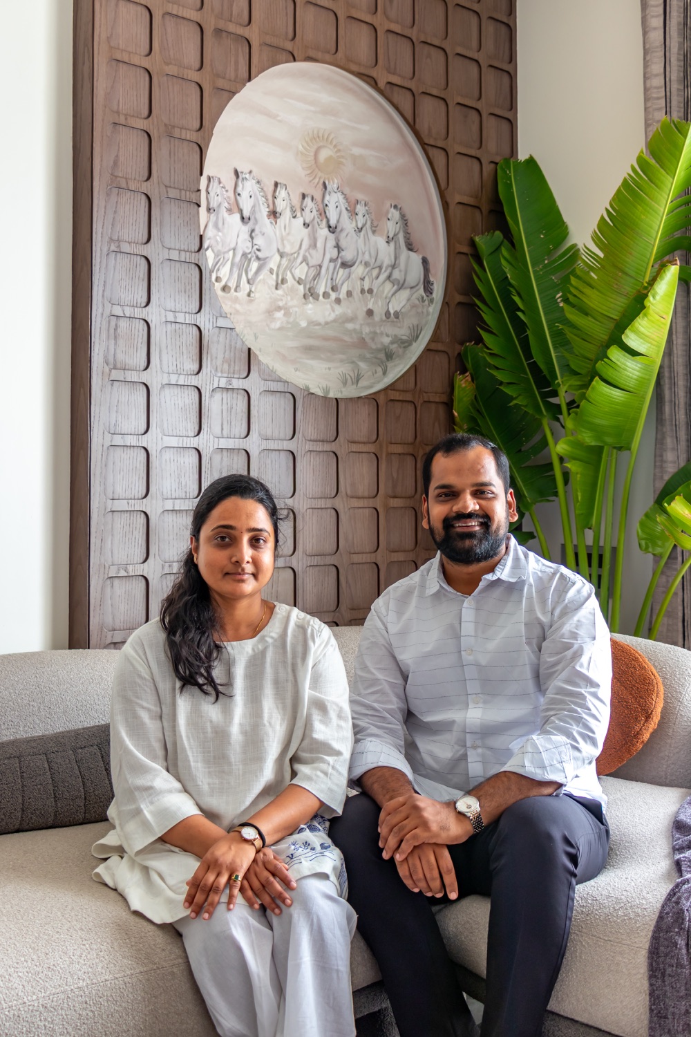 The founders in front of a carved timber wall panel and horse artwork