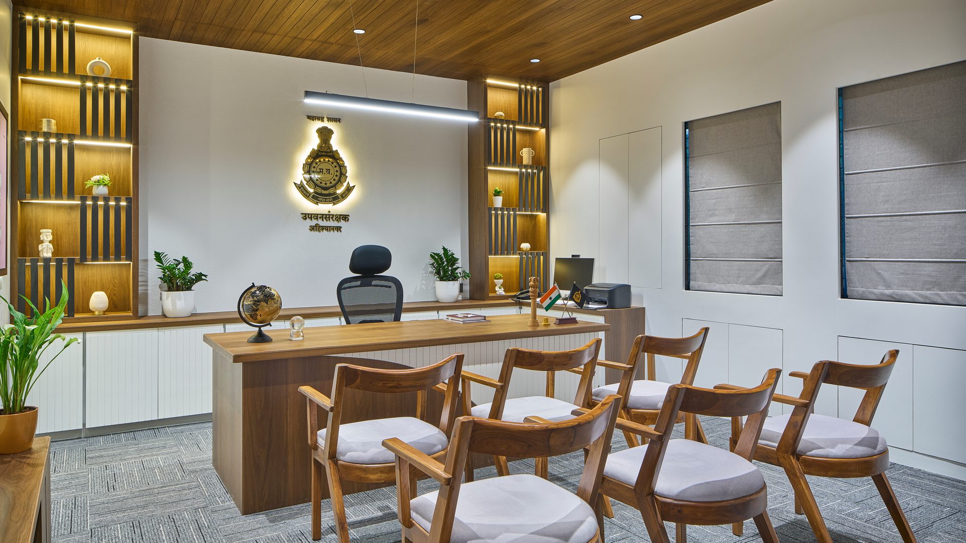 Officer’s cabin with teak-finish ceiling, backlit display shelving and timber seating — DCF Office, Ahilyanagar